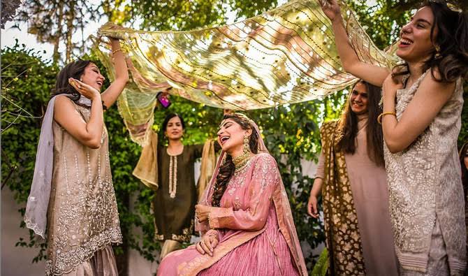 Asian Wedding Photography - Photo of an Asian Bride and her bridesmaids performing a ritual